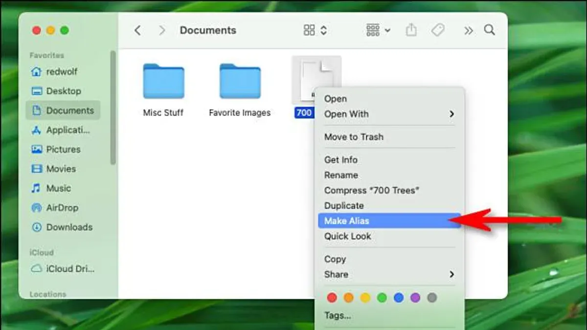 MacBook screen displaying how to create an alias in Finder on macOS