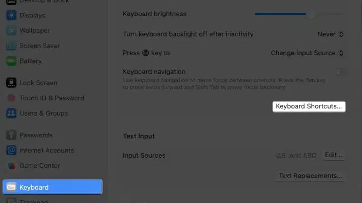 Mac keyboard shortcut to open System Settings displayed on laptop screen