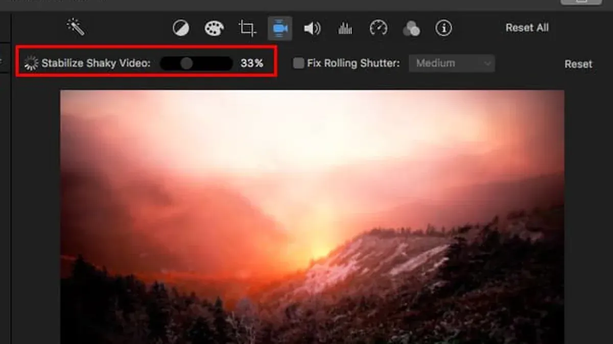 Person stabilizing shaky footage in iMovie on a laptop screen