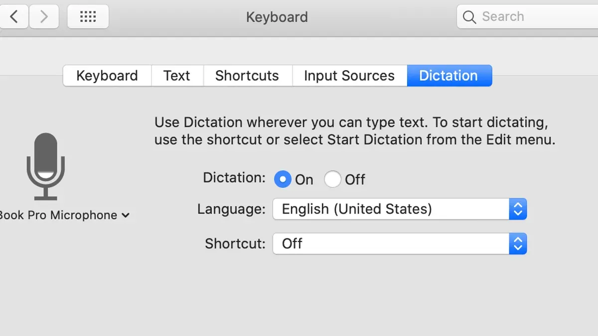 Person using dictation in Microsoft Word on Mac laptop