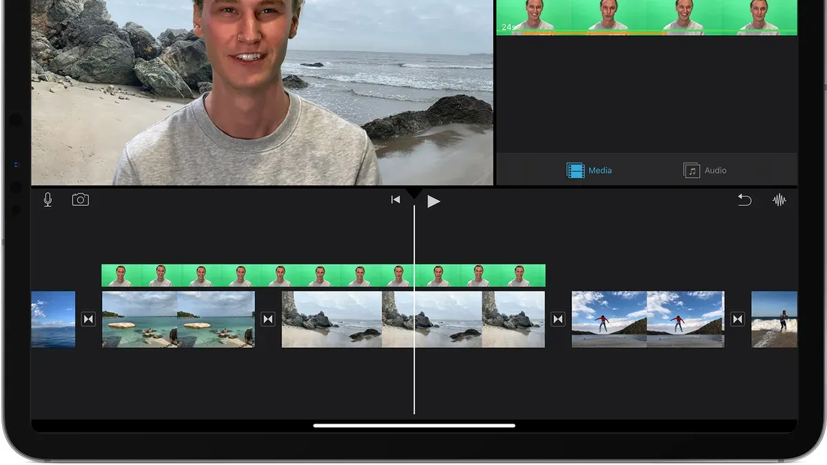 Person using iMovie to apply green screen effects in video editing software