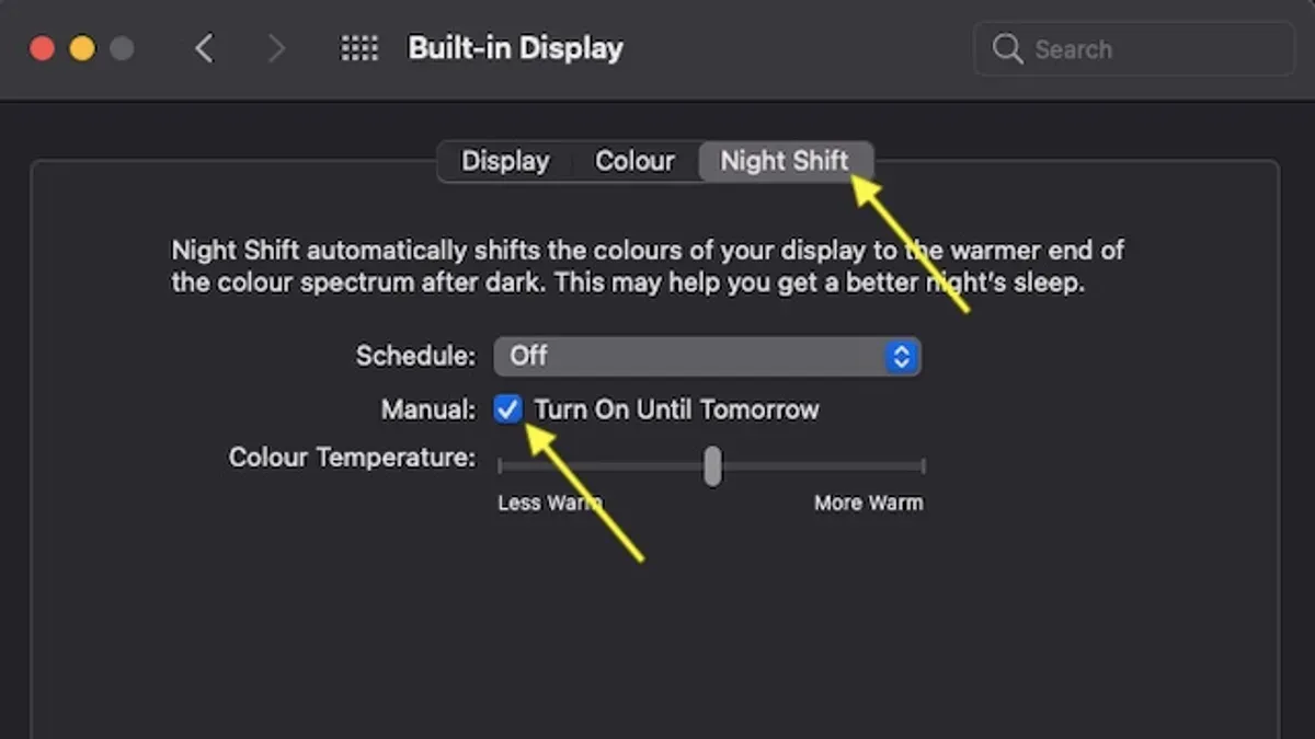 Person using MacBook adjusting Night Shift settings to reduce eye strain