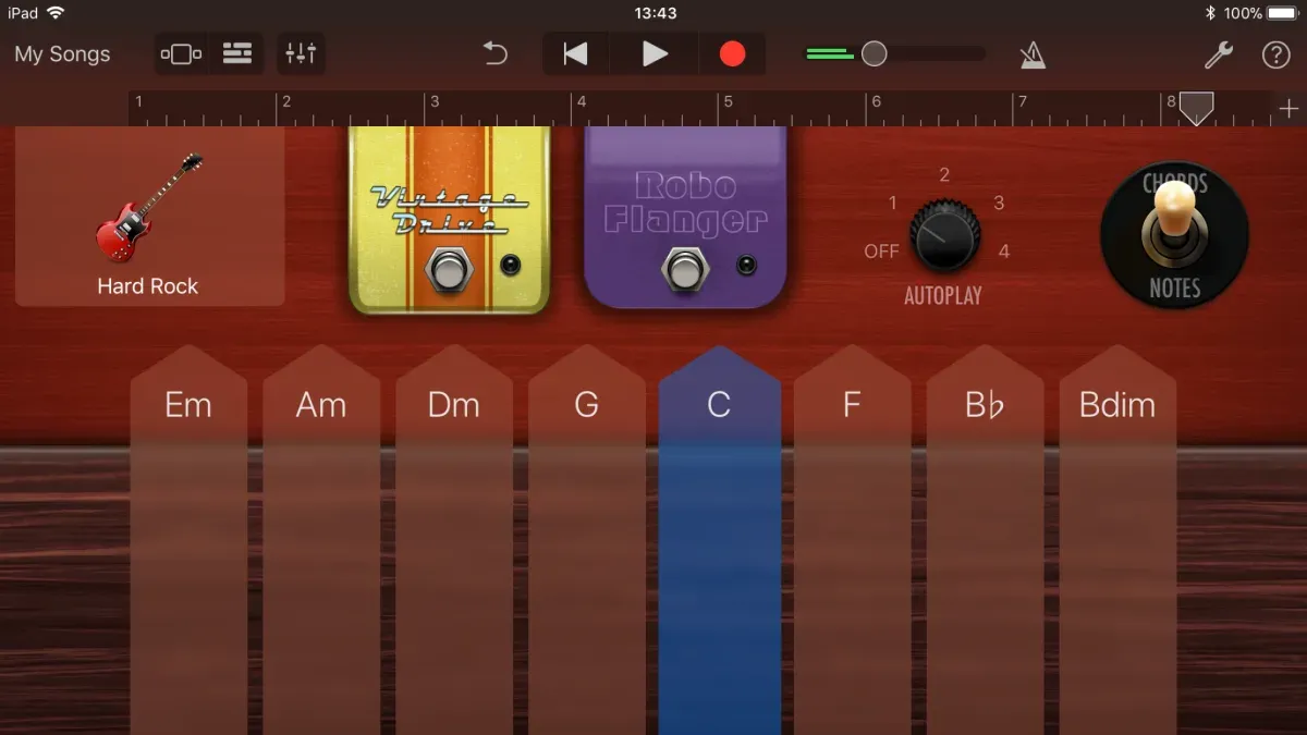 Person using GarageBand to play and customize Smart Instruments on laptop