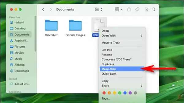 MacBook screen displaying how to create an alias in Finder on macOS