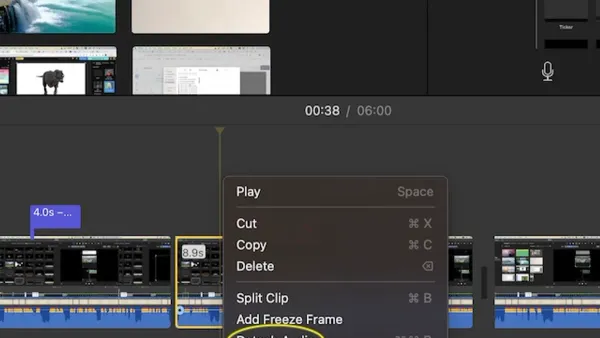 Person detaching audio from video in iMovie on a MacBook screen