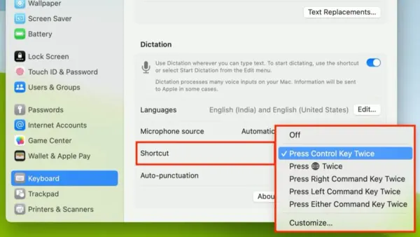 Person using Mac keyboard shortcut to turn on dictation on a laptop