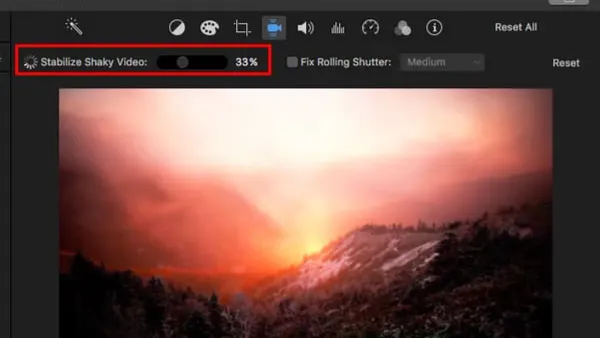 Person stabilizing shaky footage in iMovie on a laptop screen