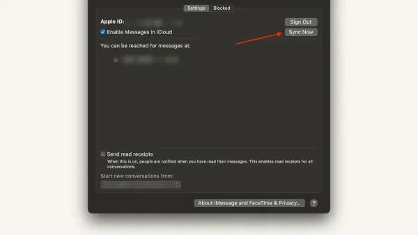 Person syncing messages on Mac with MacBook and iPhone showing message sync process