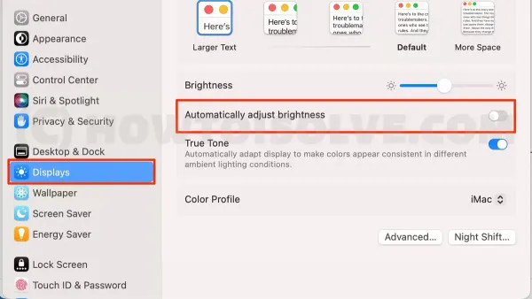 Person turning off auto brightness on Mac laptop screen